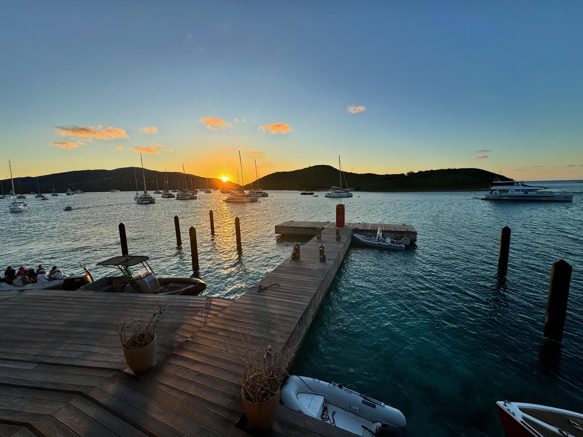 Quiet BVI anchorage at sunset during shoulder season, with calmer waters and fewer boats than peak winter months.