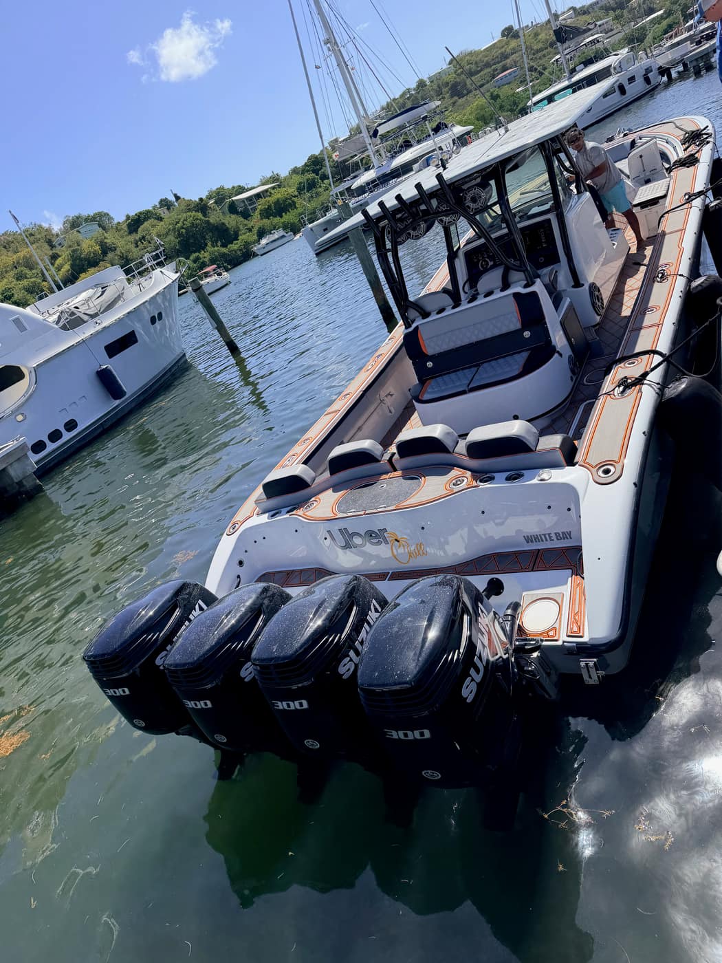 Center console boat with quad outboard engines at the dock in White Bay, St. Thomas, used for the Chillout Charters customs transfer.